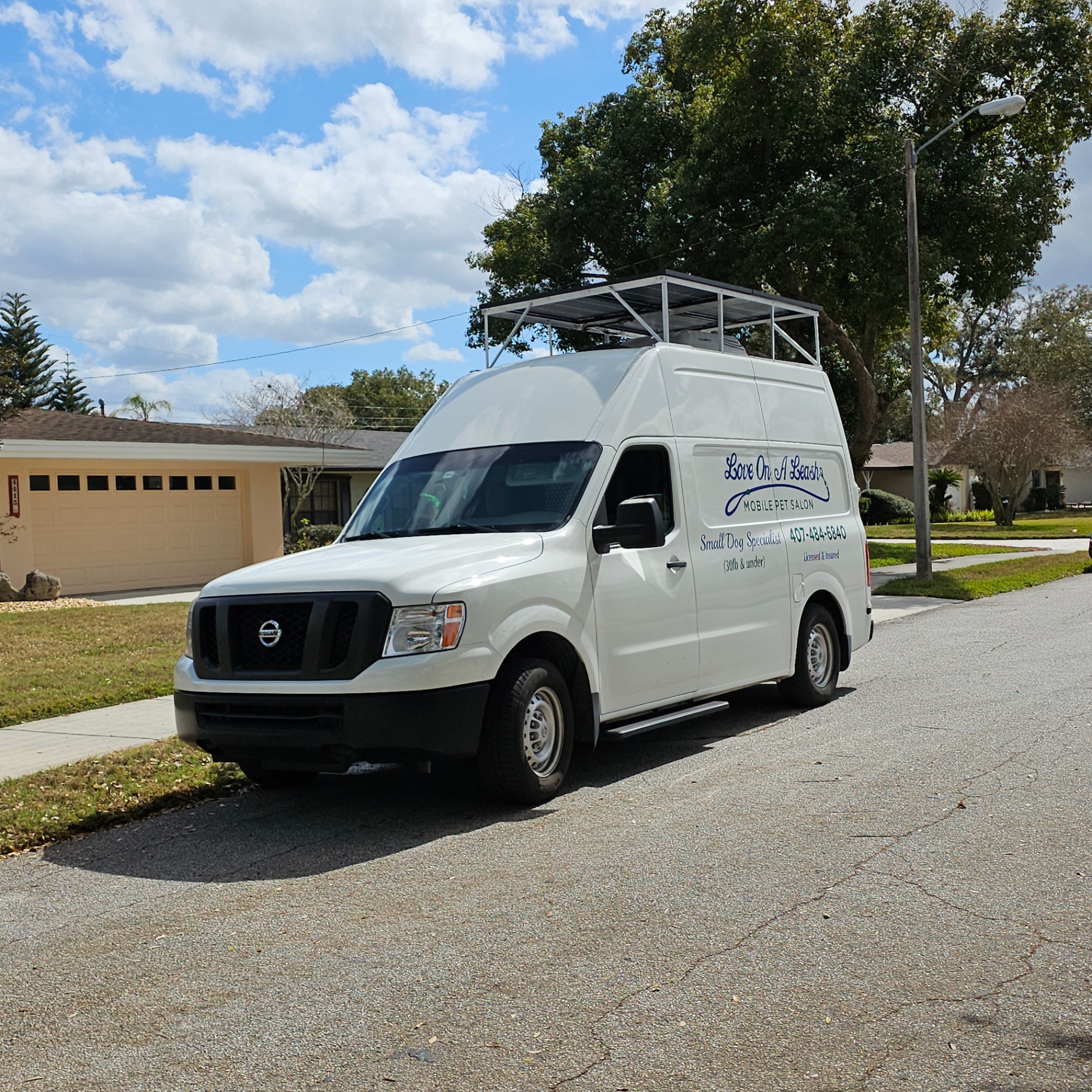 Mobile pet salon van with elevated solar rack